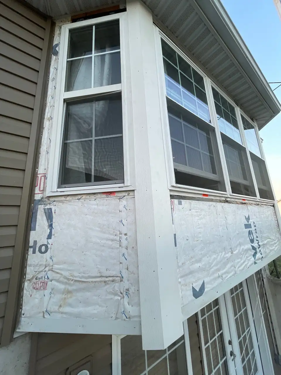 New white-framed replacement windows installed on a Missouri home during renovation