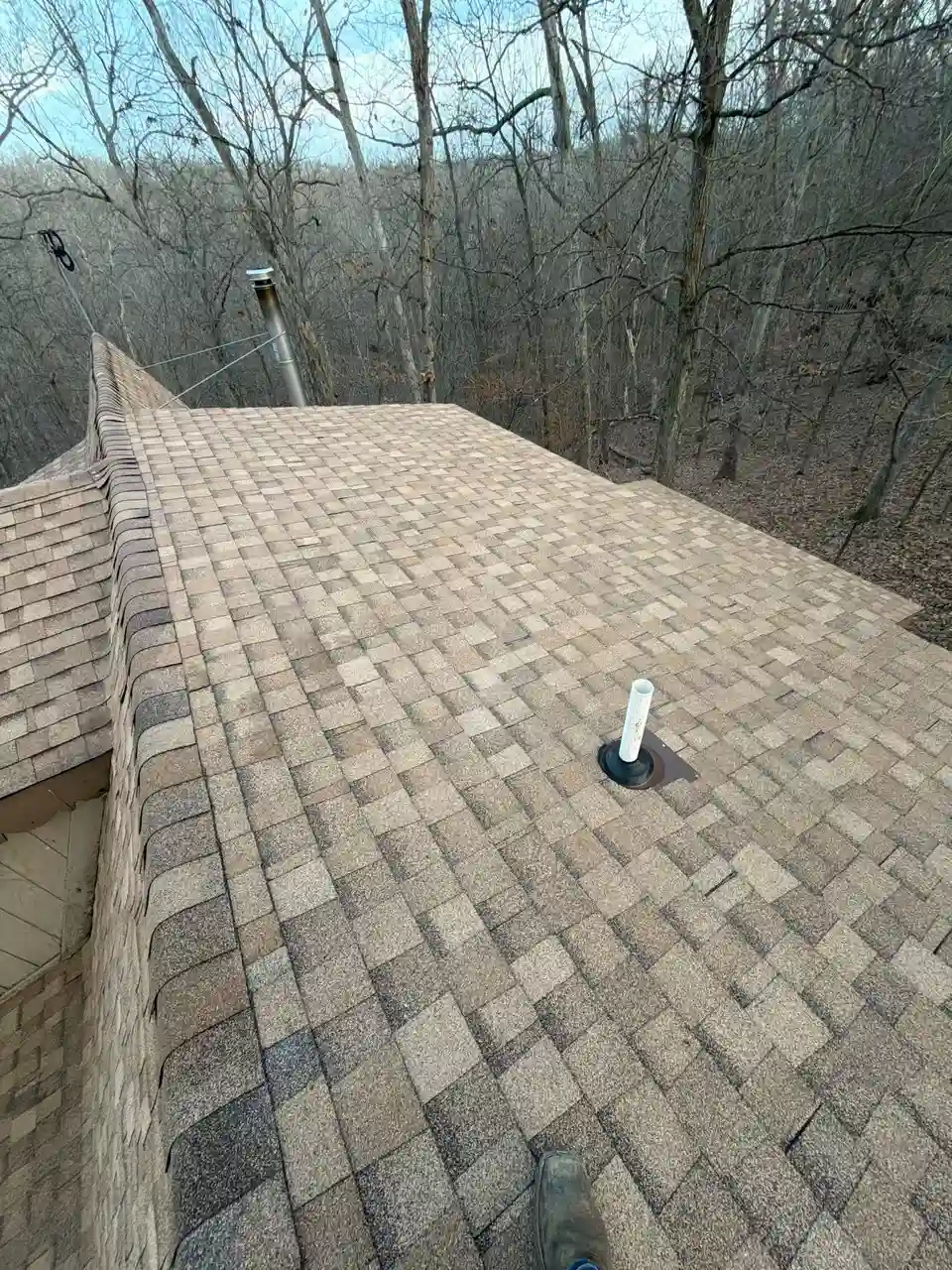 Newly installed asphalt shingle roof on a Missouri home after hail damage replacement